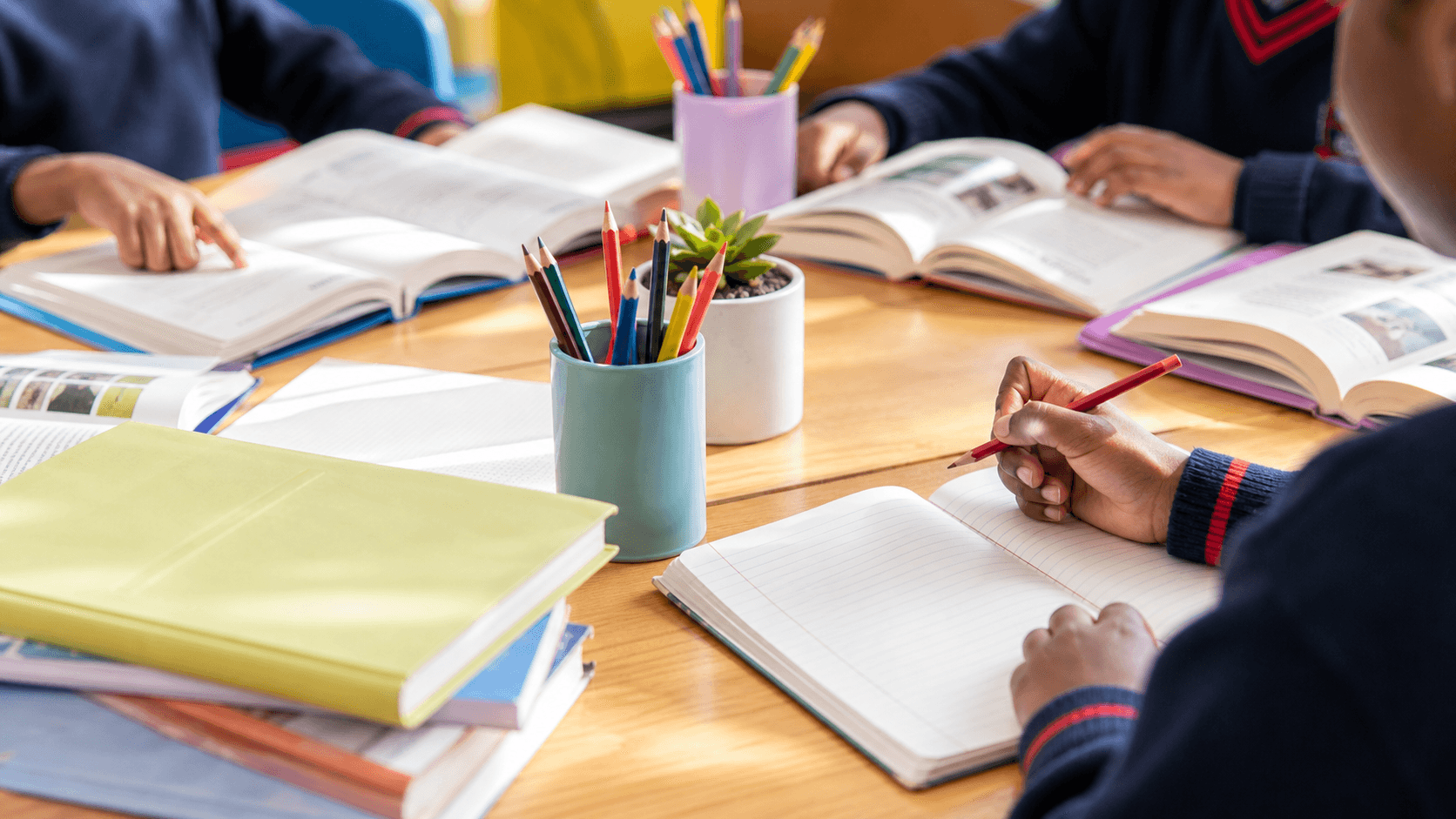 Learners reading and writing with books